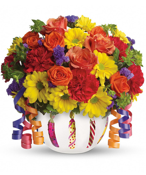 Bouquet of bright flowers in a birthday-themed vase