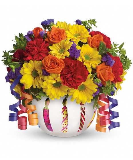 Bouquet of bright flowers in a birthday-themed vase