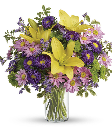 spring-themed yellow, pink, and purple flower arrangement