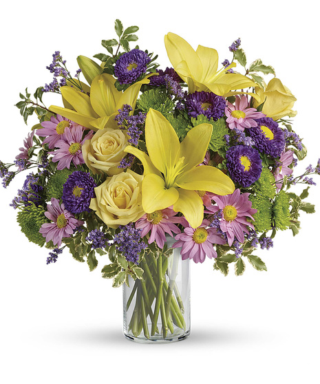 spring-themed yellow, pink, and purple flower arrangement