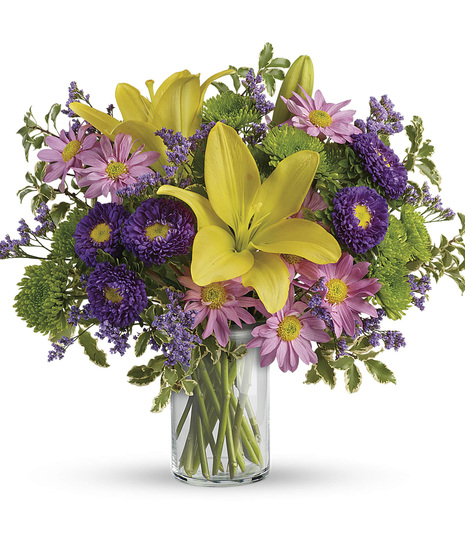 spring-themed yellow, pink, and purple flower arrangement